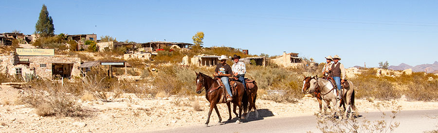 Riders on horseback enter the Ghost Town.